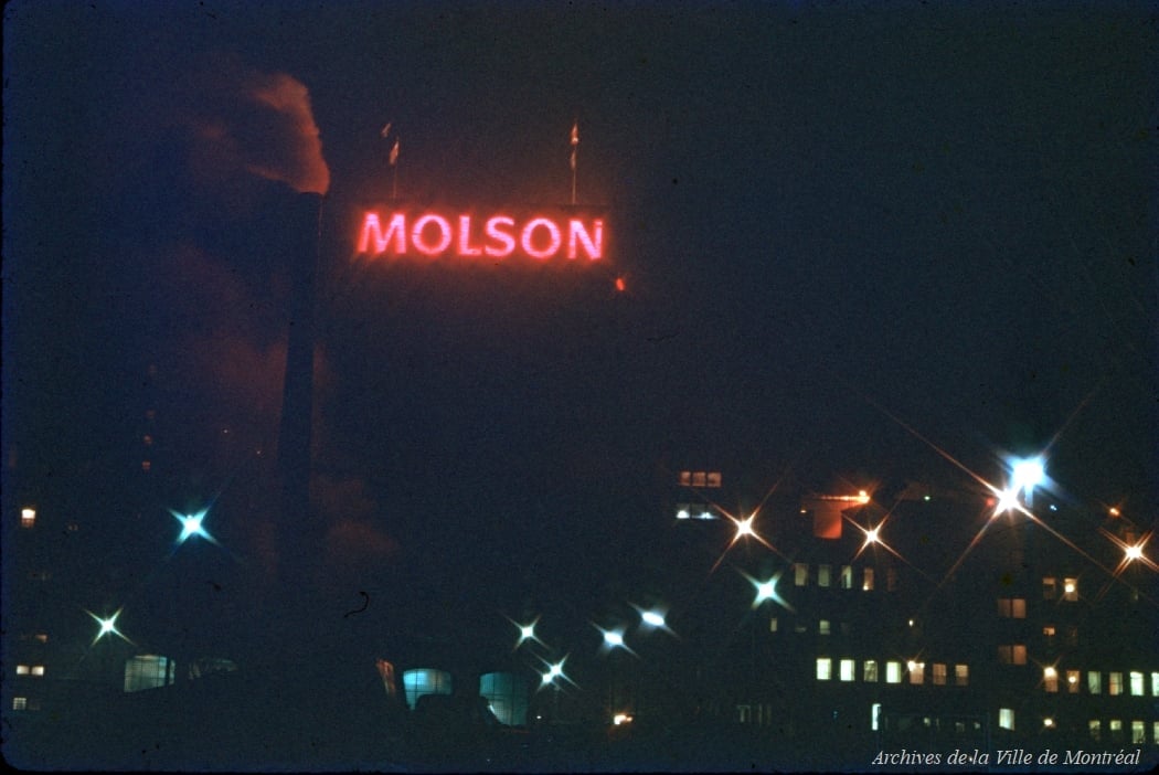 Molson Brewery at night, with its illuminated red sign